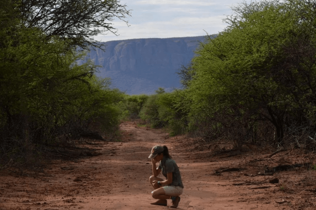  Conservationist Sabrina Colombo in the African savannah, tracking wildlife as part of LEO Africa’s mission to protect endangered species.