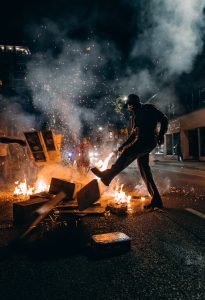 An image related to riots, such as protestors, police, or damaged property