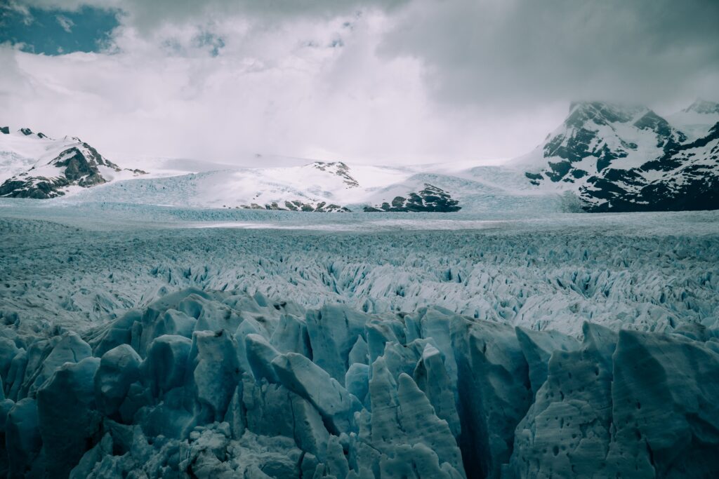 Antarctica's vast ice sheet melting under the impact of climate change, revealing the rocky continent beneath and raising global sea levels