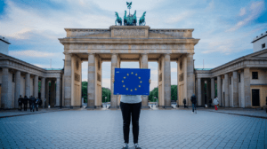 An EU Blue Card holder standing in front of the Brandenburg Gate, symbolizing a new start in Germany.